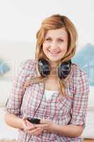 Happy blond-haired woman with headphones and mp3 player