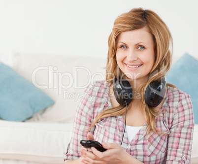 Attractive blond-haired woman with headphones and mp3 player