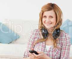 Attractive blond-haired woman with headphones and mp3 player