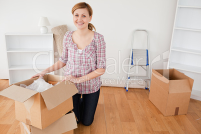 Young blond-haired woman preparing to move house