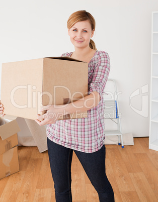 Cute woman carrying cardboard boxes