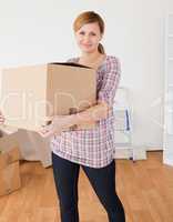 Cute woman carrying cardboard boxes