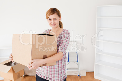 Attractive woman carrying cardboard boxes