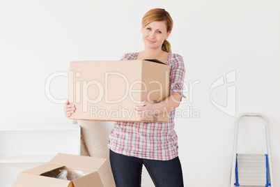Blond-haired woman carrying cardboard boxes