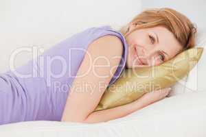 Attractive blonde woman resting while lying on the sofa