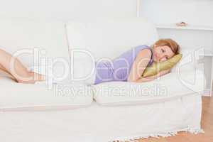 Cute blonde woman resting while lying on the sofa