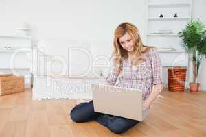 Blond-haired woman surfing on her laptop