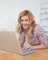 Blond-haired woman chatting on her laptop