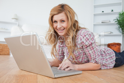 Blond-haired woman looking at the camera while chatting on her l