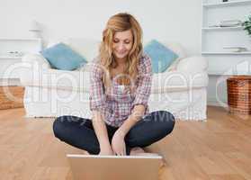 Blonde woman surfing on her laptop