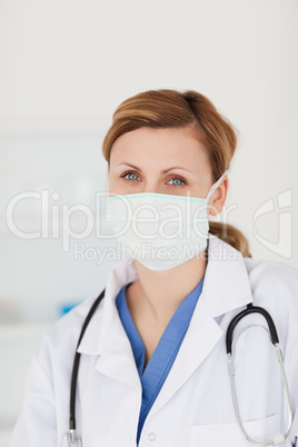 Blond-haired scientist with a mask and a stethoscope posing