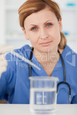 Female scientist preparing an experiment with a pipette and a be