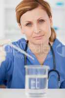 Female scientist preparing an experiment with a pipette and a be