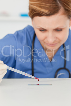 Female scientist preparing a microscope slid