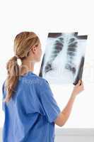 Cute female doctor looking at an X-ray