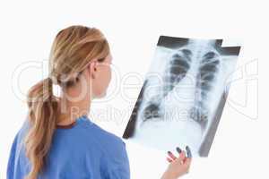 Cute blond-haired doctor looking at an X-ray