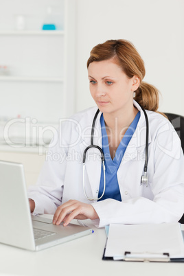 Concentrated doctor working on her laptop