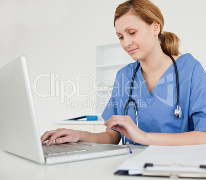 Young female doctor working on her laptop