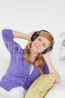 Portrait of a beautiful red-haired woman listening to music and