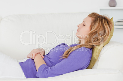 Attractive woman taking a rest lying on a sofa