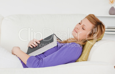 Beautiful woman lying on the sofa who has fallen asleep while re
