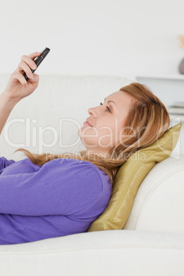 Profile portrait of an attractive woman writing a text message w