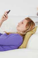 Profile portrait of an attractive woman writing a text message w