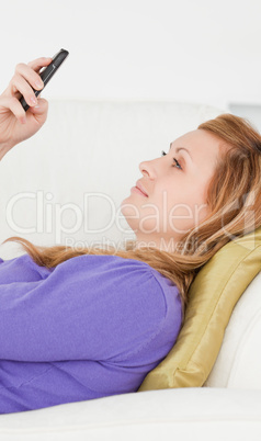 Profile portrait of a good looking woman writing a text message