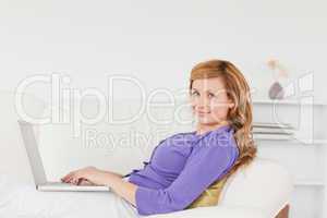 Beautiful red-haired woman using a laptop