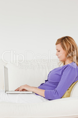 Good loooking red-haired woman using a laptop