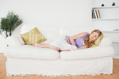 Attractive woman taking a rest while lying on a sofa