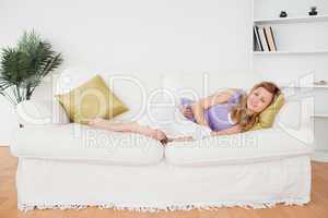 Attractive woman taking a rest while lying on a sofa
