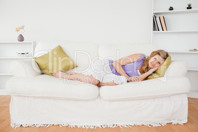 Attractive woman taking a rest while lying on a sofa