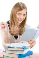 Student teenager woman write homework with book