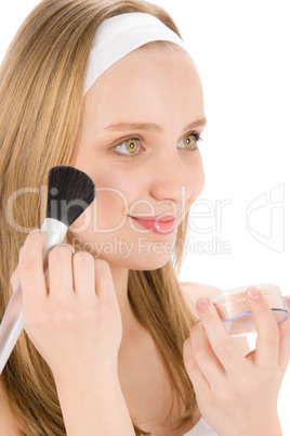 Facial care teenager woman apply powder with brush