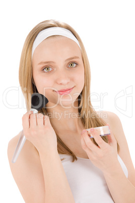 Facial care teenager woman apply powder with brush