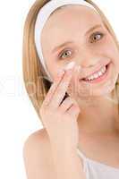 Facial care teenager woman apply cream