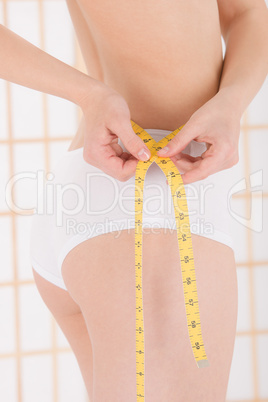 Beauty body care young woman measuring waist