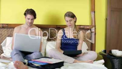 Young couple working from home with pc