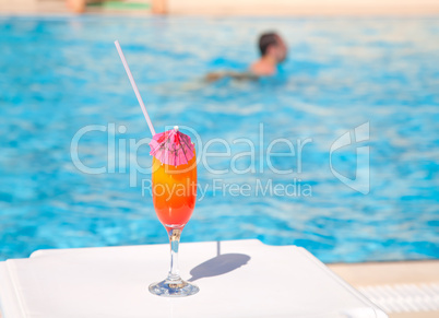 Cocktail glass with umbrella and straw