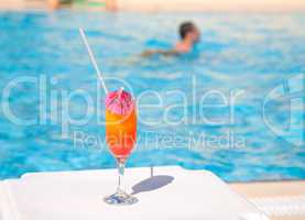 Cocktail glass with umbrella and straw