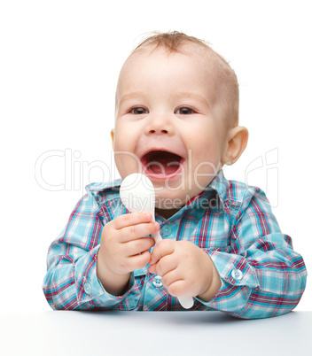 Cute little boy with white spoon