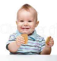 Cute little boy is holding cookies and smile