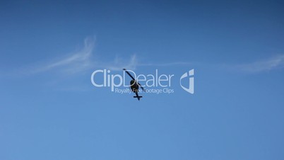 Helicopter acrobatic flaying on blue sky