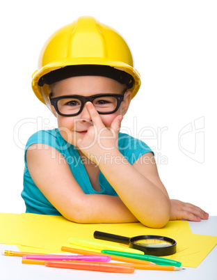 Cute little girl is playing while wearing hard hat