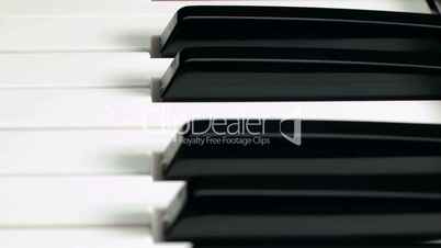 Sequence: closeup of piano keyboard. Dolly shot