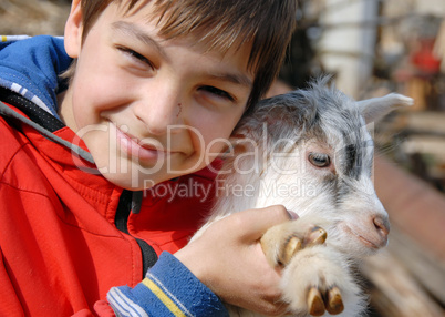 Teenage boy with goatling