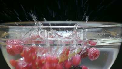 Blackberries and raspberries splashing in water