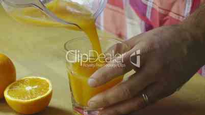 Man preparing fresh orange juice at home