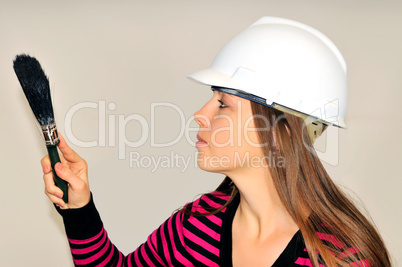 Girl in a helmet with a paintbrush